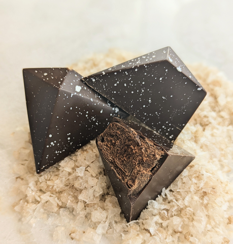 Dark chocolate truffles on a bed of sea salt crystals